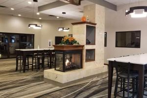 a fireplace in a room with tables and chairs at Howard Johnson by Wyndham Lima in Lima