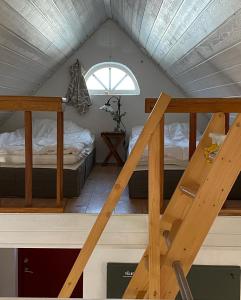 a room with two bunk beds and a staircase at BRICK Österlen in Simrishamn