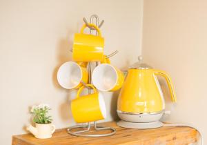 a shelf with cups and a tea kettle on a table at Tipperary House Dublin in Dublin