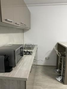 a kitchen with white cabinets and a counter top at Studio Ra Mamaia-Nord in Mamaia Sat/Năvodari