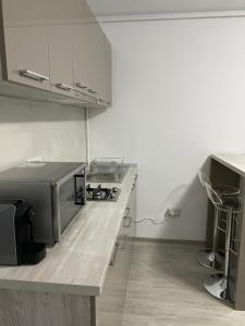 a kitchen with white cabinets and a counter top at Studio Ra Mamaia-Nord in Mamaia Sat/Năvodari +11 photos
