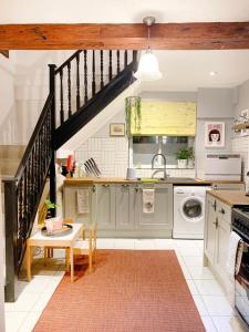 a kitchen with a staircase and a sink at Old Barrel Store - Old Town. Parking & Garden in Margate