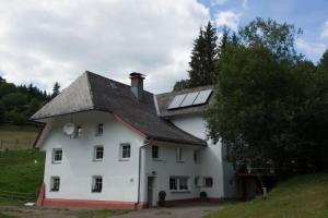 een wit huis met zonnepanelen op het dak bij Zur alten Oele - Hochwertig und Familienfreundlich in Lenzkirch