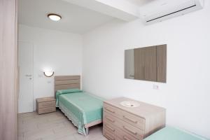 A bed or beds in a room at Residenza Le Tartarughe