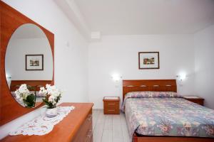 A bed or beds in a room at Residenza Le Tartarughe