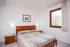 A bed or beds in a room at Residenza Le Tartarughe
