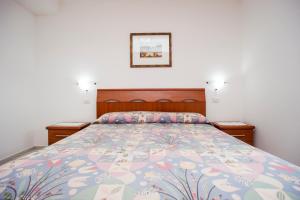 A bed or beds in a room at Residenza Le Tartarughe