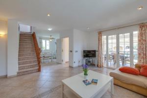 a living room with a couch and a table at Villa Loli in Alcudia
