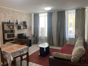 a living room with a couch and a table at Oksana's Apartments - Nevsky 64 in Saint Petersburg