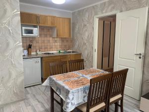 a kitchen with a table with a table cloth on it at Oksana's Apartments - Nevsky 64 in Saint Petersburg