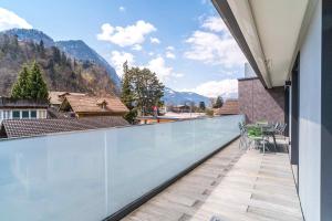 a balcony with a view of the mountains at Apartment Ankebälleli - GriwaRent AG in Interlaken