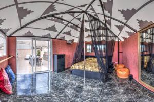 a bedroom with a canopy bed in a room with a table at Semi-detached villa sea views, huge terrace, close beach in Palm-mar