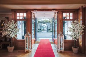 an open door with a red carpet in a hallway at Castle Arch Hotel in Trim