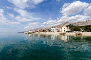a group of houses on the shore of a body of water at Villa Fontana in Starigrad-Paklenica