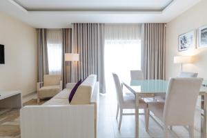 a living room with a table and chairs at Maritim Antonine Hotel & Spa in Mellieħa