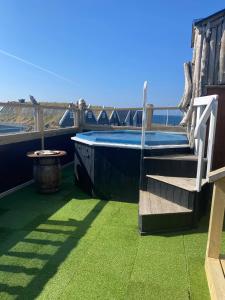 a hot tub on the roof of a house at Hlid Fisherman's Village in Álftanes
