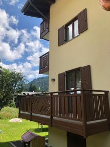 a balcony of a house with brown doors and windows at Appartamento del rosengarten in Madonna di Campiglio