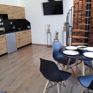 a kitchen and dining room with a table and chairs at Apartament w Pieninach in Krościenko