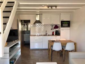 eine Küche und ein Esszimmer mit Tisch und Stühlen in der Unterkunft Melroce Holiday Cottage 5504 in Bredene