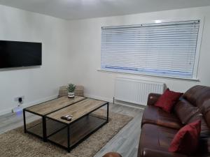 a living room with a couch and a coffee table at No 14 in Wick