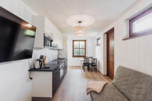 a kitchen and living room with a couch and a table at Ferienhaus Schilfvilla in Mörbisch am See