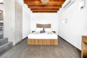 a bedroom with a bed and a wooden ceiling at Belvedere in Livadi