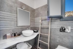 a bathroom with a sink and a mirror at Belvedere in Livadi