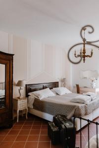 a bedroom with a bed with two suitcases on the floor at Casa Barbabuc in Novello