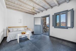 a bedroom with a bed and a table at Belvedere in Livadi