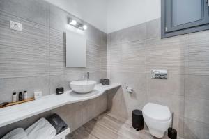a bathroom with a sink and a toilet at Belvedere in Livadi