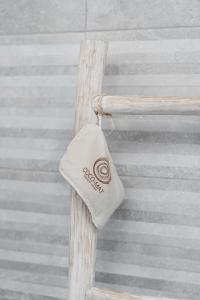 a hat hanging from the side of a wooden cross at Belvedere in Livadi