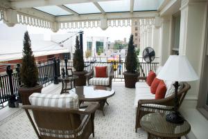 a balcony with furniture and a table and chairs at Capital Hotel in Little Rock