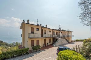 a building with a car parked in front of it at Bel Soggiorno lake view 1 in Tremosine Sul Garda