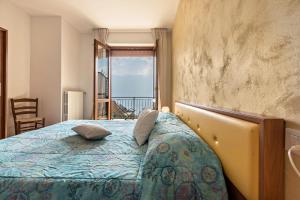 a bedroom with a bed with a view of the ocean at Bel Soggiorno lake view 1 in Tremosine Sul Garda