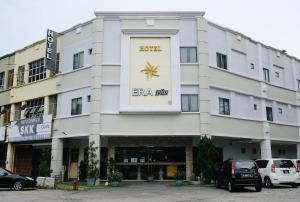 史里肯邦安的住宿－Era Plus Hotel，一座白色的大建筑,上面有标志