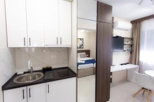 a small bathroom with a sink and a bed at Villa BonnaDea in Valjevo