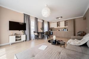 a living room with a couch and a table at Comfy luxury center apartment in Varna City