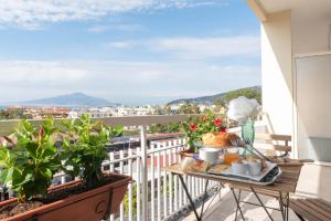 a breakfast table on a balcony with a view at B&B Sirentum in Sorrento