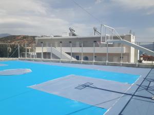 an empty swimming pool with a building in the background at Antigoni in Agia Galini