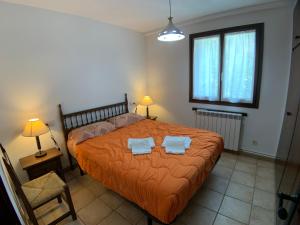a bedroom with a bed with two towels on it at B36 - Mayor 48, 1º - Villmor in Benasque