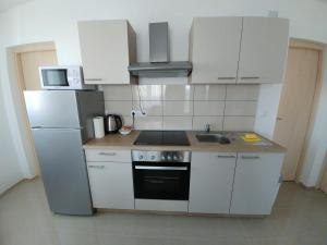 Kuchyň nebo kuchyňský kout v ubytování Apartmani Valuna
