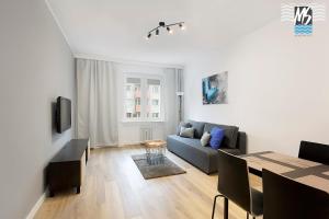a living room with a couch and a table at MS Apartments Centrum Gdyni II in Gdynia