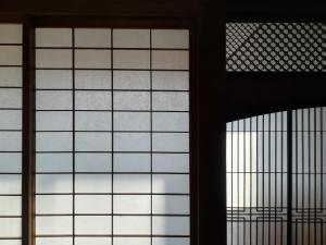 two windows in a building with the sky seen through them at 旧鈴木邸 女性専用 in Matsuyama