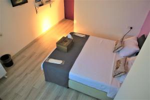 a bedroom with a bed with a bag on it at Lavender Otel in Cesme