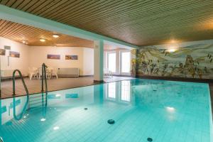 a large swimming pool with a painting on the wall at Haus Weesterhuk Whg 8 in Keitum