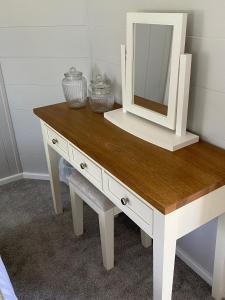 a white dressing table with a mirror on top at Hollicarrs - Newlands in York