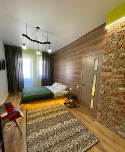 a bedroom with a bed and a brick wall at Apart-Hotel у центрі Трускавця in Truskavets +8 photos