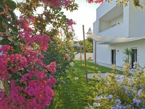 a garden of flowers in front of a house at Green Land B&B Boutique in Castilenti