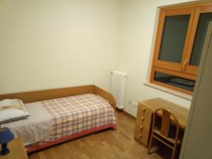 a small bedroom with a bed and a window at A CASA DI LUCA E GLORIA 2 in Giulianova