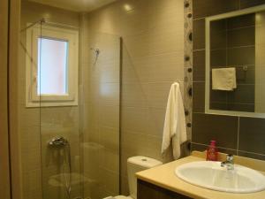 y baño con ducha y lavamanos. en Villa Eleftheria, en Vitalades